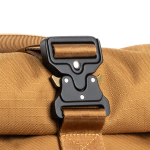 Quick-release parachute-style buckle secures the expandable roll top compartment
