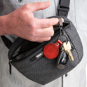 Main compartment has a key lanyard and microfiber-lined stash pocket for phones or power banks