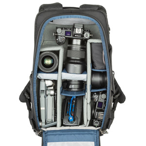 1-2 ungripped DSLR body or Mirrorless System with 70–200mm f/2.8 attached, 2-5 additional lenses, a flash, 16” laptop, plus personal gear.