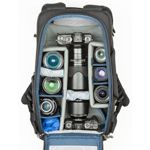 1-2 ungripped DSLR body or Mirrorless System with 70–200mm f/2.8 attached, 2-5 additional lenses, a flash, 16” laptop, plus personal gear.