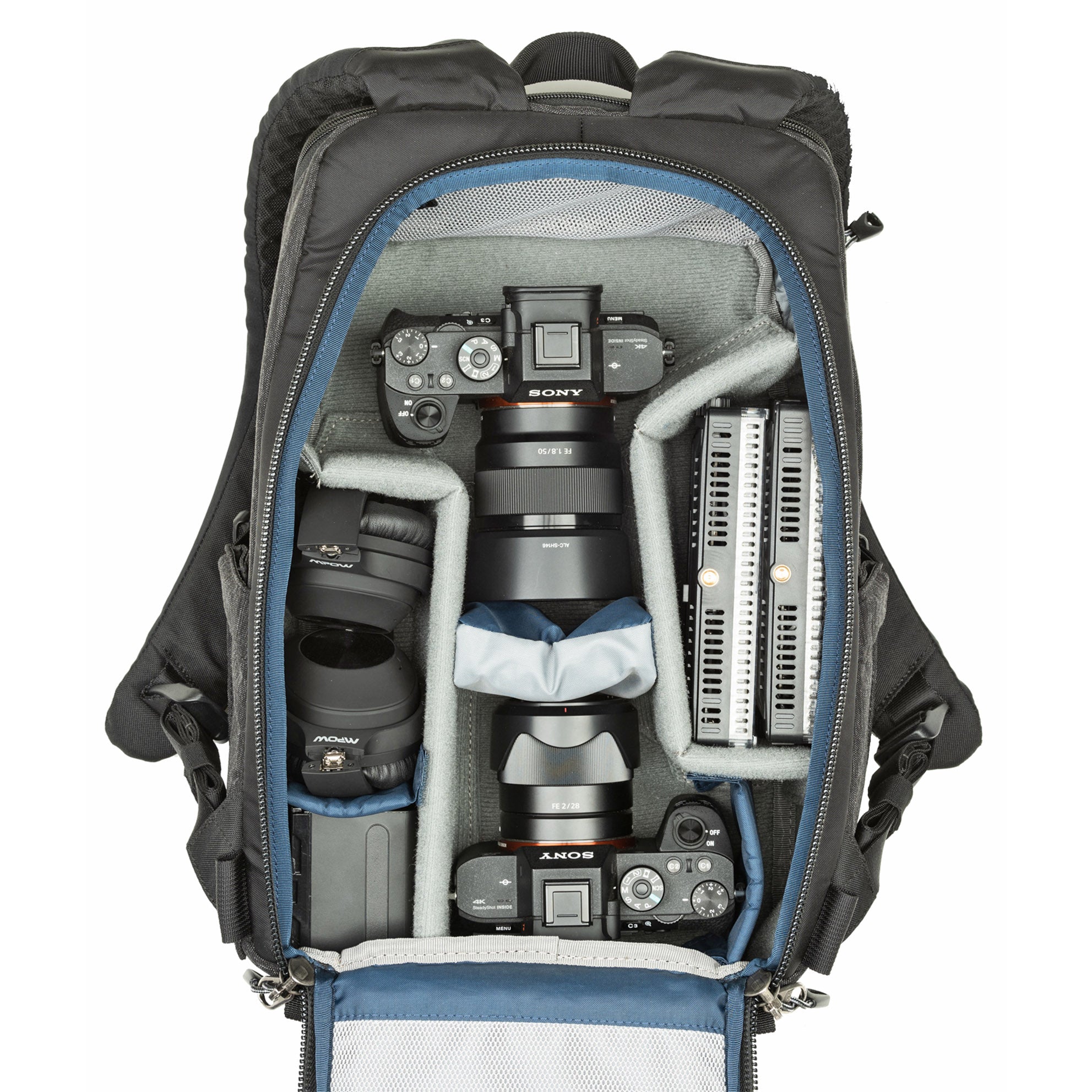 1–2 ungripped DSLR or Mirrorless body with lens attached up to a 70–200mm f/2.8, 1–3 additional lenses, a strobe, a 13” laptop, plus personal gear