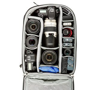 Gripped DSLR with 70-200mm f/2.8 attached, three additional lenses, gripped body, audio and video accessories