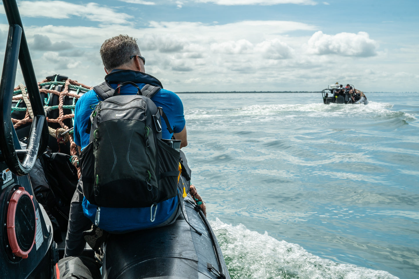 Ian Urbina, author of The Outlaw Ocean, looks out to sea off The Gambian coast while carrying his MindShift TrailScape 18L backpack from Think Tank Photo.