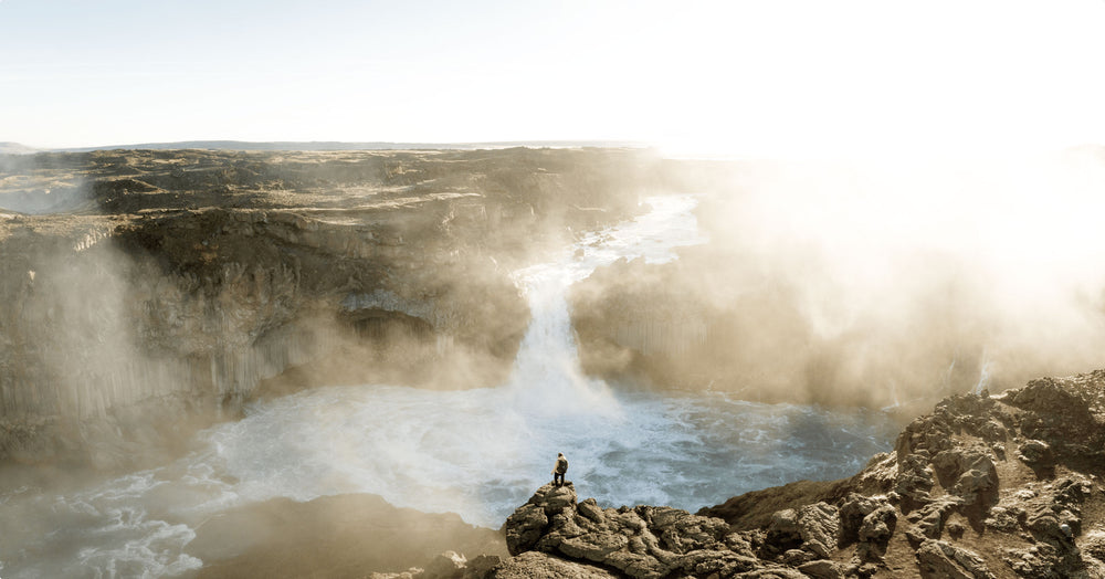 Highlands of Iceland Scenery overlooking a waterfall with misty fog and sunrise