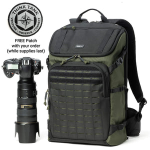 A green DarkLight 25L camera backpack with tactical-style design, alongside a camera and lenses. There's also an offer badge indicating a free patch with the order.