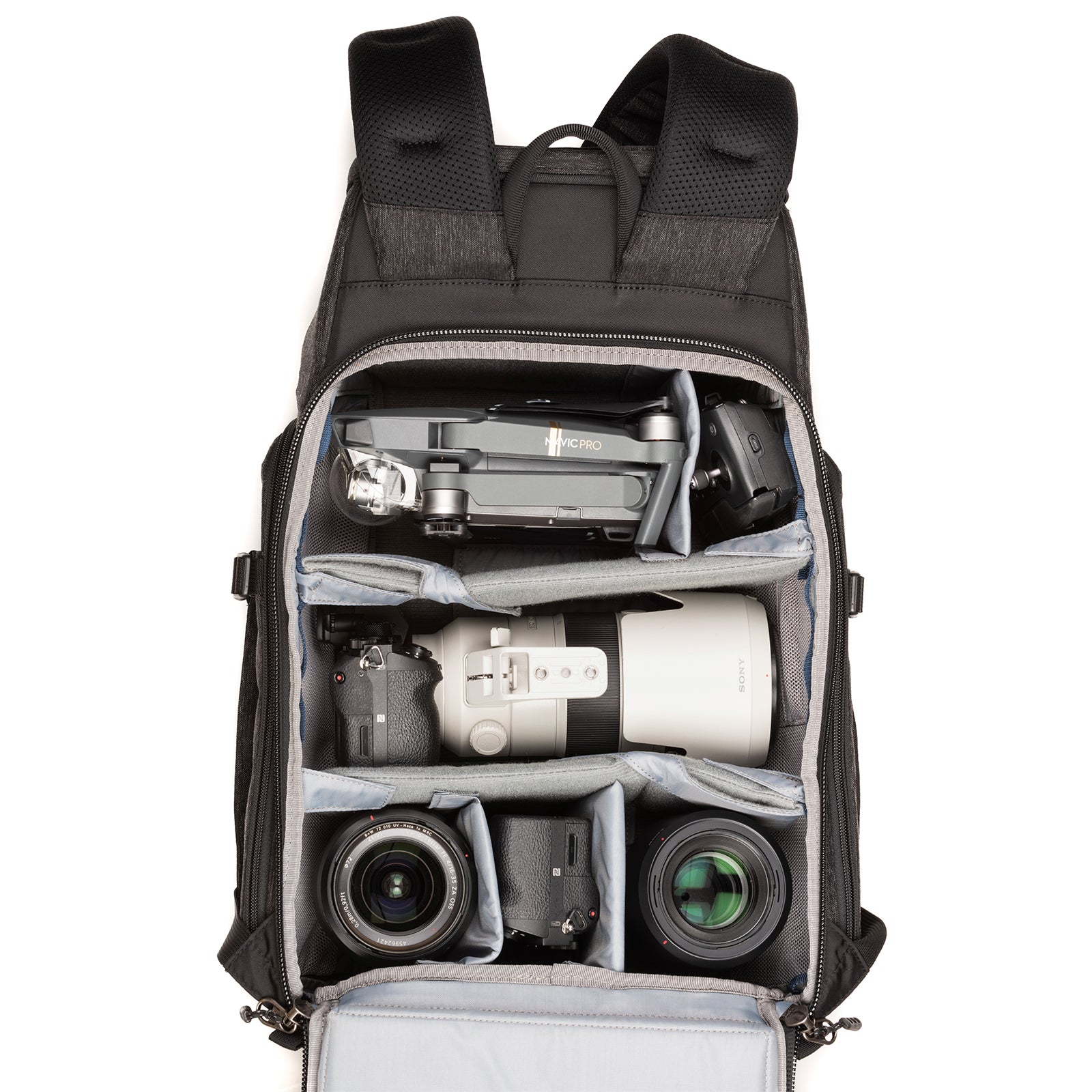 1 ungripped DSLR or Mirrorless body with lens attached up to a 70–200mm f/2.8, 3–5 additional lenses, a strobe, a 15” laptop, plus personal gear