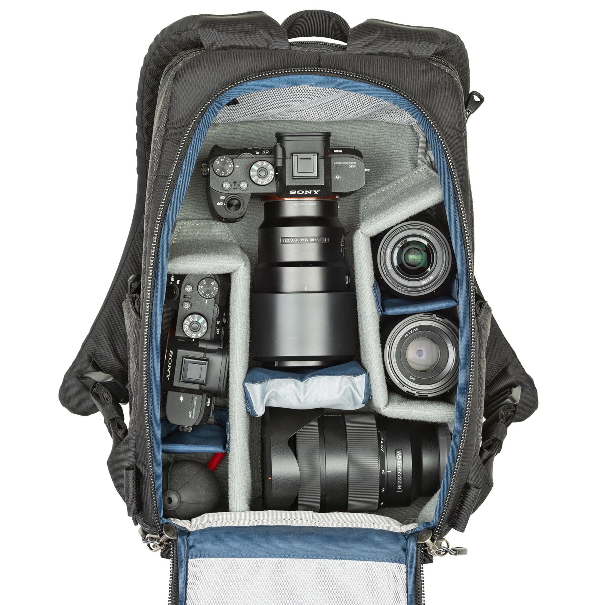 1–2 ungripped DSLR or Mirrorless body with lens attached up to a 70–200mm f/2.8, 1–3 additional lenses, a strobe, a 13” laptop, plus personal gear