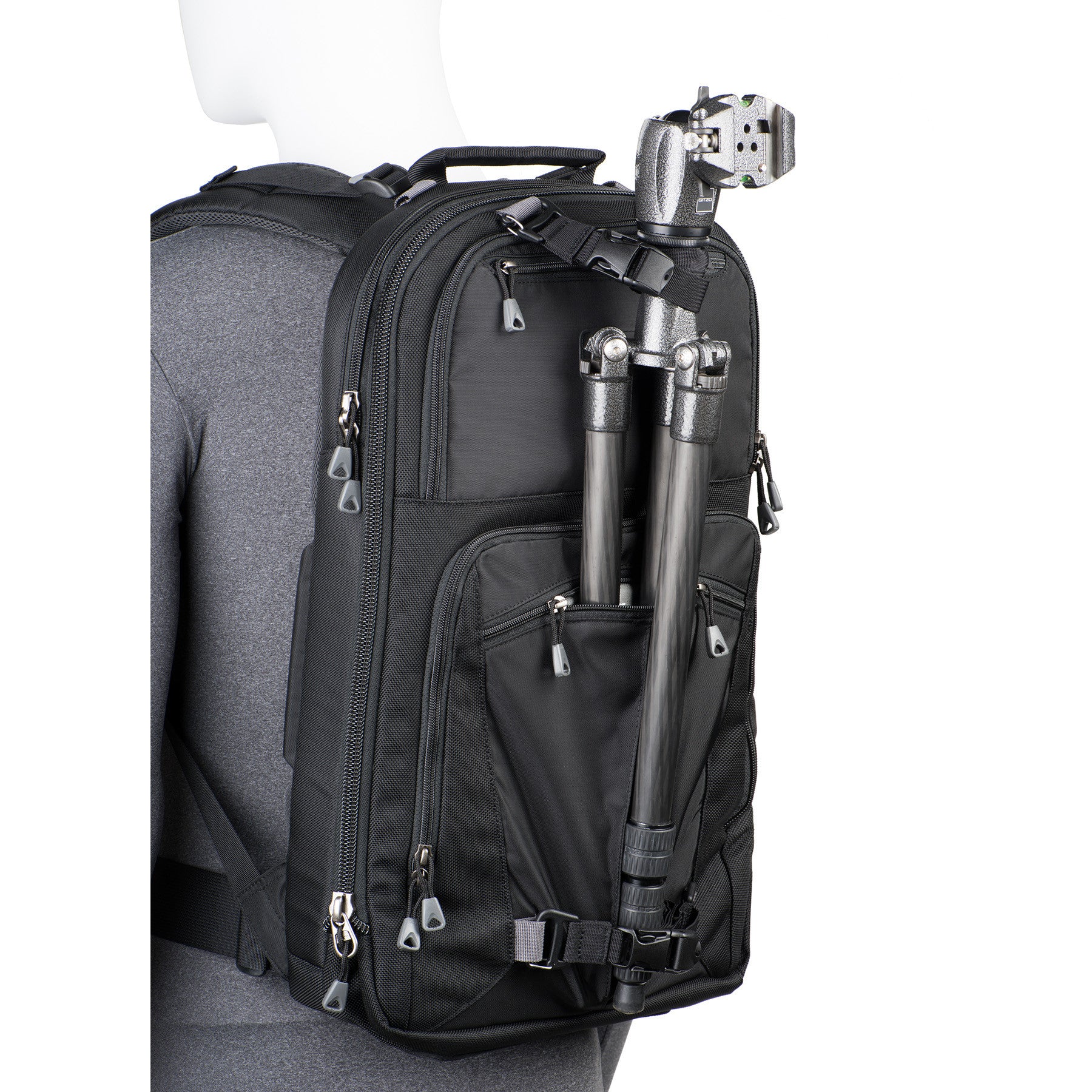 Tripod carry on front of bag keeps weight centered and allows you to access gear without detaching the tripod