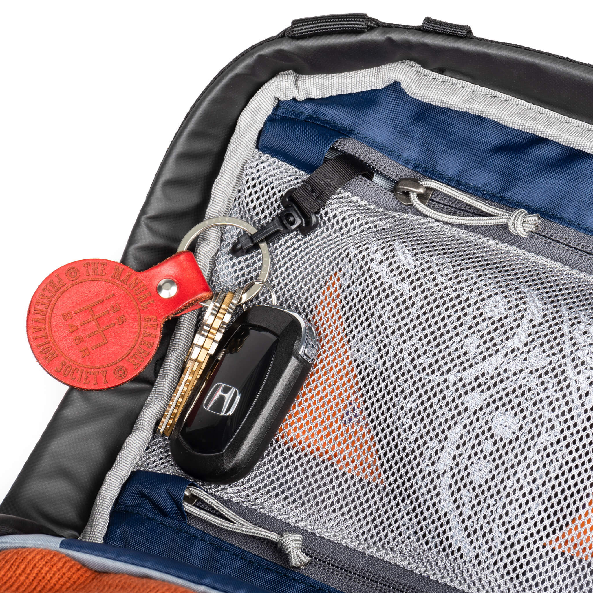 Two zippered mesh pockets with key lanyard in the top compartment secures small items