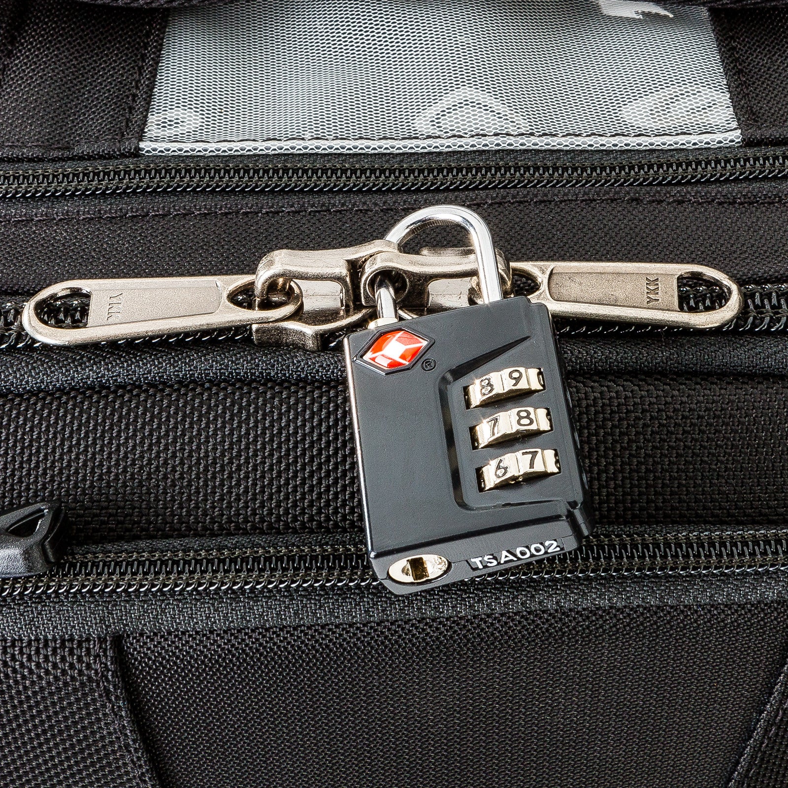 Locking zipper sliders on main compartment